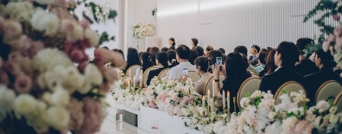Wedding guests taking photos during a ceremony