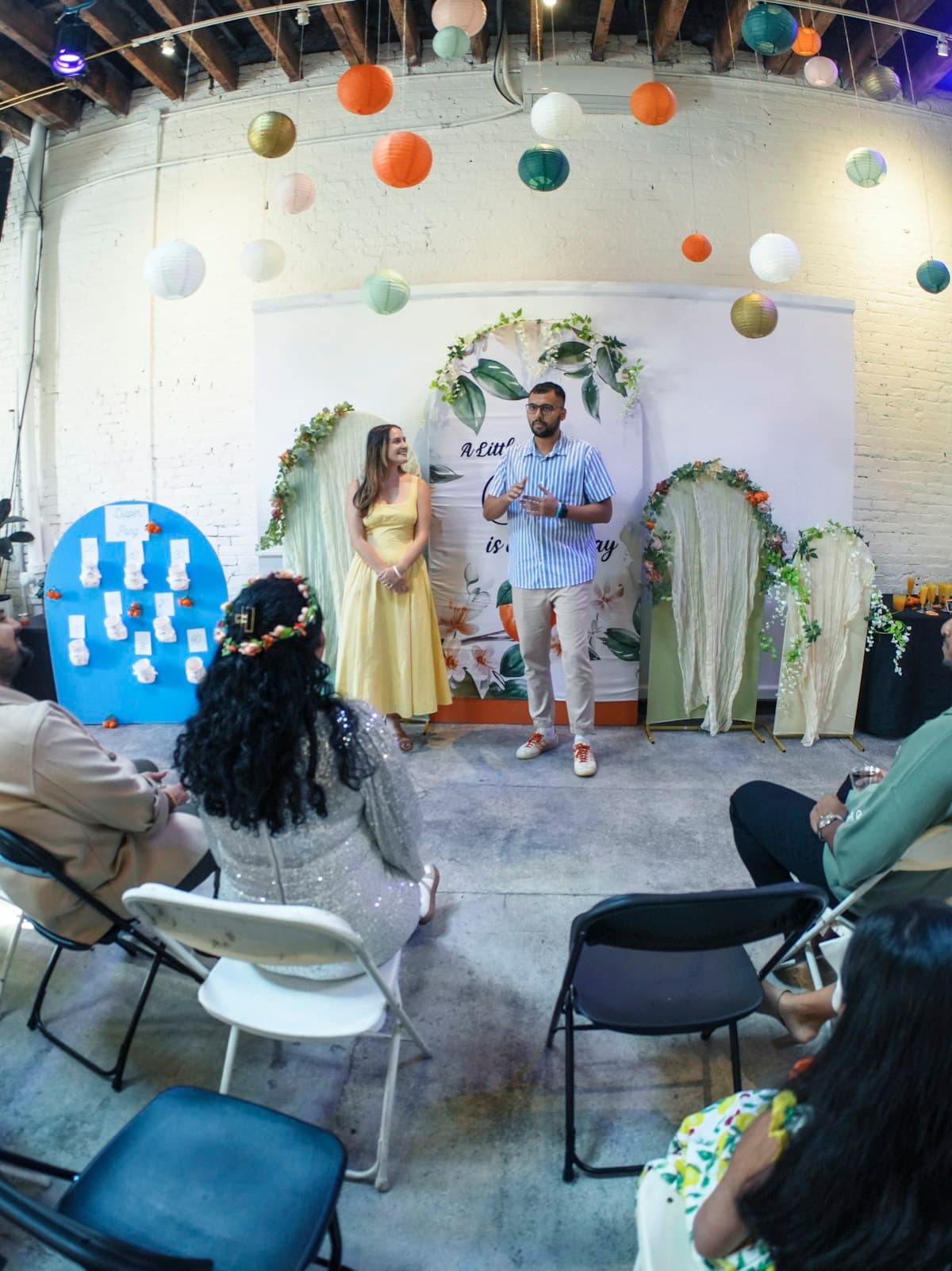 Guests watching two people speak at a celebration
